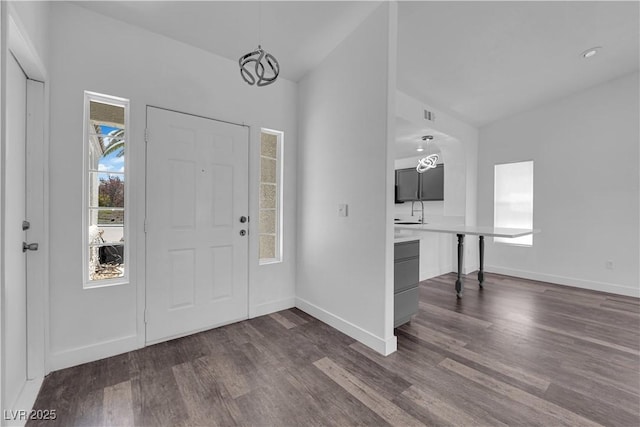 6129 Bedrock Ct, North Las Vegas, NV 89031 - entrance foyer featuring dark wood-style floors, vaulted ceiling, and a chandelier