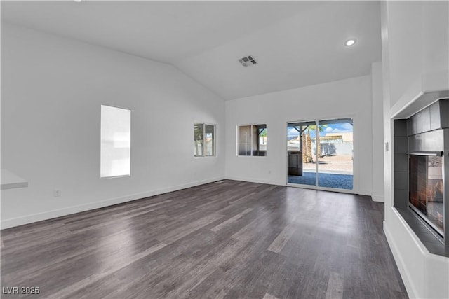 6129 Bedrock Ct, North Las Vegas, NV 89031 - unfurnished living room featuring dark wood-type flooring, lofted ceiling, and recessed lighting