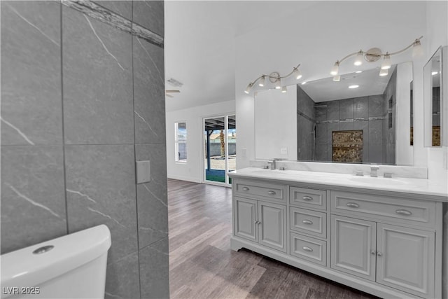 6129 Bedrock Ct, North Las Vegas, NV 89031 - full bath with tile walls, double vanity, wood finished floors, and a shower