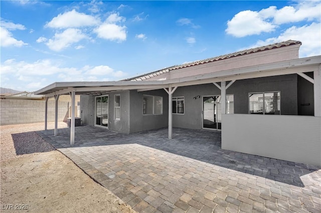 6129 Bedrock Ct, North Las Vegas, NV 89031 - back of house featuring stucco siding, a patio area, and a tiled roof