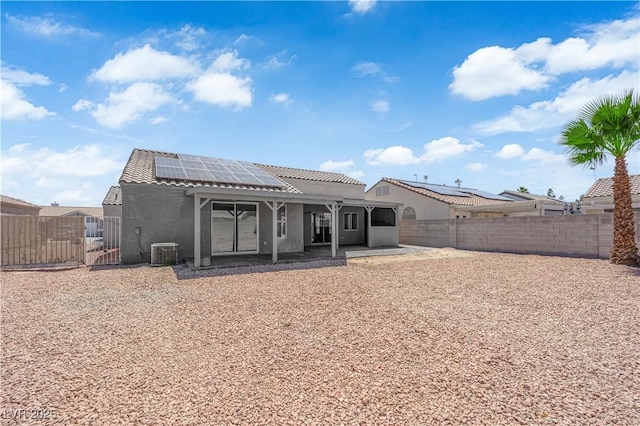 6129 Bedrock Ct, North Las Vegas, NV 89031 - back of house featuring a gate, solar panels, a fenced backyard, and a patio area