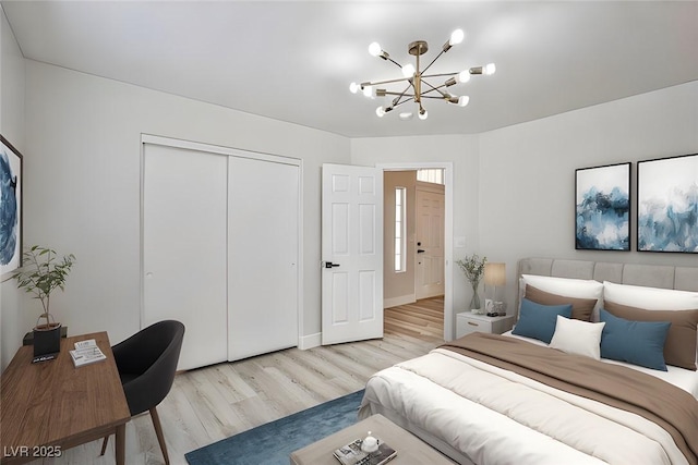 1002 Christopher View Ave, North Las Vegas, NV 89032 - bedroom with light wood-style flooring, a chandelier, and a closet