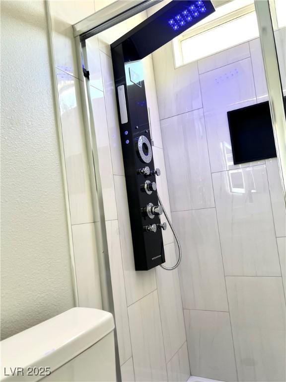 1002 Christopher View Ave, North Las Vegas, NV 89032 - full bathroom with a shower stall and a textured wall
