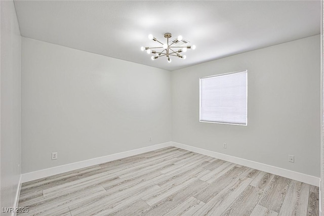 1002 Christopher View Ave, North Las Vegas, NV 89032 - empty room with light wood finished floors and a chandelier