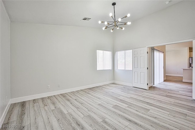 1002 Christopher View Ave, North Las Vegas, NV 89032 - unfurnished room featuring a chandelier, light wood-type flooring, and high vaulted ceiling