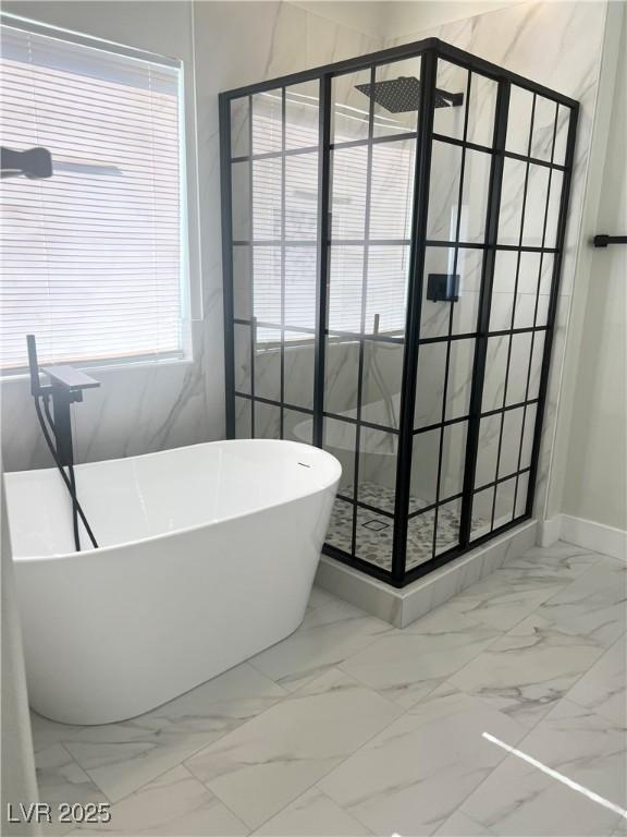 1002 Christopher View Ave, North Las Vegas, NV 89032 - full bathroom with marble finish flooring, a stall shower, and a freestanding tub