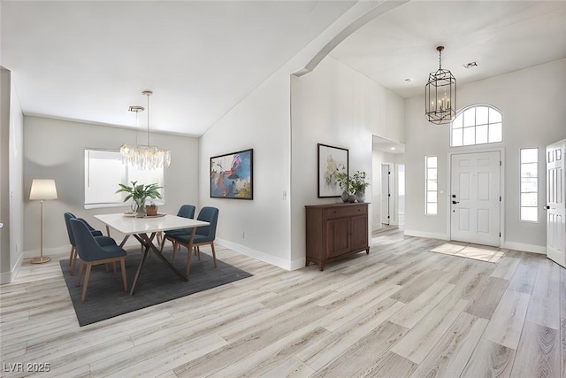 1002 Christopher View Ave, North Las Vegas, NV 89032 - entrance foyer featuring a chandelier, light wood-style floors, a high ceiling, and arched walkways