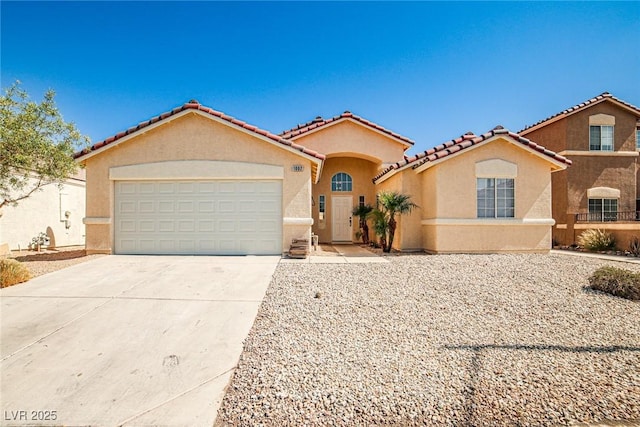 1002 Christopher View Ave, North Las Vegas, NV 89032 - mediterranean / spanish-style house featuring stucco siding, driveway, an attached garage, and a tiled roof