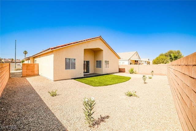 1002 Christopher View Ave, North Las Vegas, NV 89032 - rear view of property featuring stucco siding, a fenced backyard, and a patio