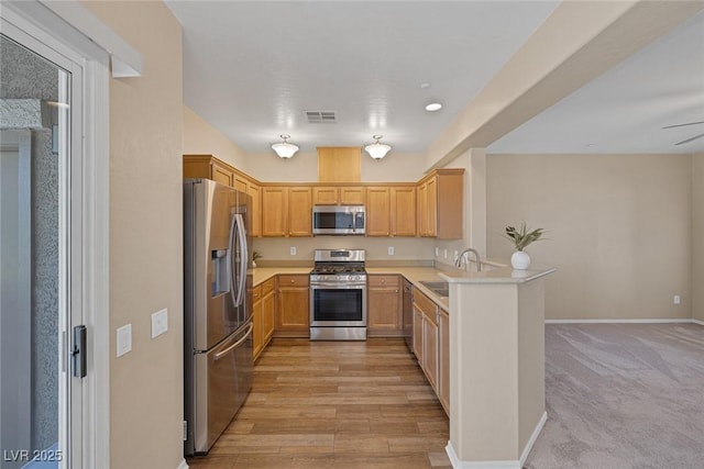 4625 Centisimo Dr Unit 202, North Las Vegas, NV 89084 - kitchen featuring appliances with stainless steel finishes, a peninsula, light countertops, open floor plan, and recessed lighting