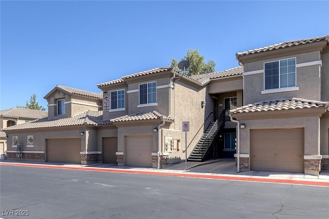 4625 Centisimo Dr Unit 202, North Las Vegas, NV 89084 - view of front of house with stucco siding, stone siding, and a tiled roof