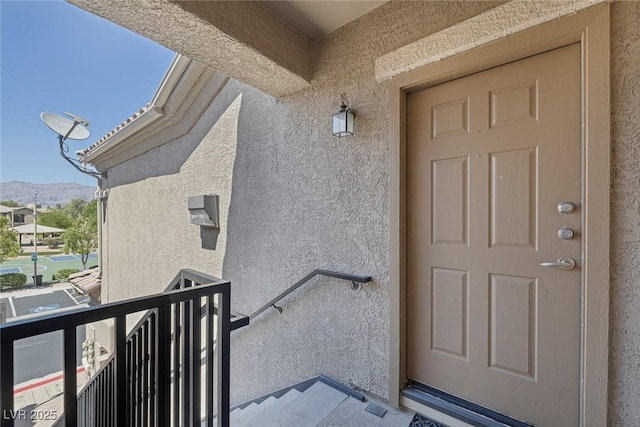 4625 Centisimo Dr Unit 202, North Las Vegas, NV 89084 - doorway to property with stucco siding, a mountain view, and a balcony