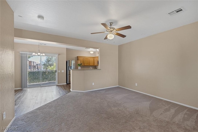 4625 Centisimo Dr Unit 202, North Las Vegas, NV 89084 - unfurnished living room with a ceiling fan, a chandelier, and carpet