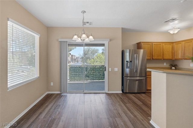 4625 Centisimo Dr Unit 202, North Las Vegas, NV 89084 - kitchen with stainless steel fridge with ice dispenser, a chandelier, dark wood-style floors, decorative light fixtures, and light countertops
