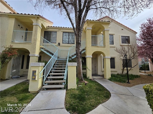 4855 S Torrey Pines Dr Unit 201, Las Vegas, NV 89103 - view of front of property with stucco siding, a tile roof, and stairway