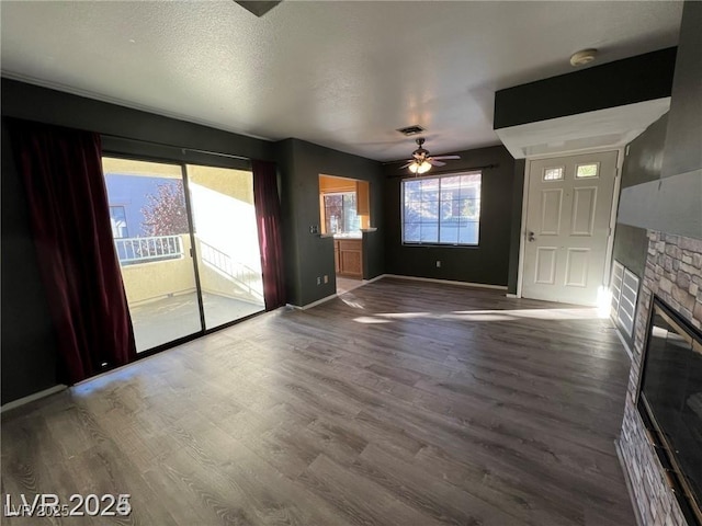 4855 S Torrey Pines Dr Unit 201, Las Vegas, NV 89103 - unfurnished living room featuring a fireplace, ceiling fan, and wood finished floors