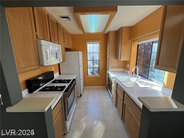 4855 S Torrey Pines Dr Unit 201, Las Vegas, NV 89103 - kitchen with white appliances, light countertops, and brown cabinetry