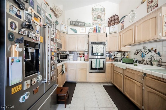 3648 Glen Ridge Way, Las Vegas, NV 89108 - kitchen with stainless steel appliances, tile countertops, decorative backsplash, and light tile patterned floors
