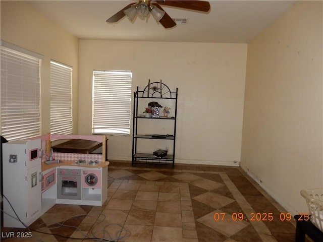 3428 Strawberry Roan Rd, North Las Vegas, NV 89032 - unfurnished dining area with a ceiling fan and tile patterned floors