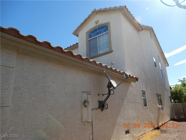 3428 Strawberry Roan Rd, North Las Vegas, NV 89032 - view of side of home with a tile roof and stucco siding