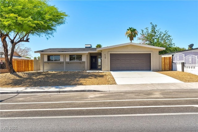 4135 E Harmon Ave, Las Vegas, NV 89121 - ranch-style home featuring stucco siding, an attached garage, and concrete driveway
