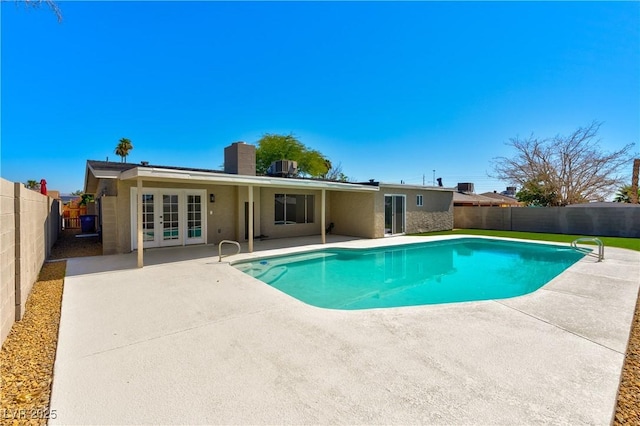 4135 E Harmon Ave, Las Vegas, NV 89121 - view of pool featuring french doors, a patio area, and a fenced backyard