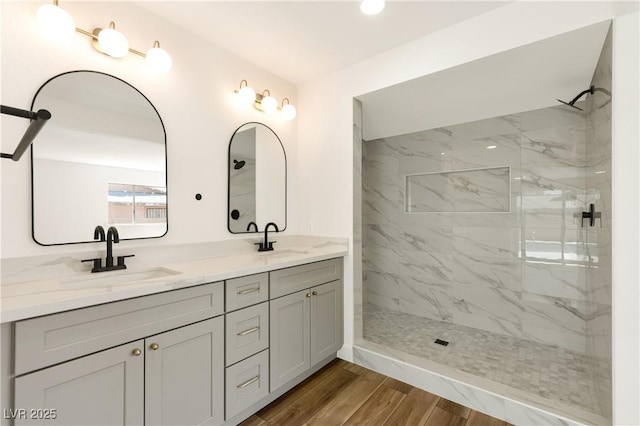 4135 E Harmon Ave, Las Vegas, NV 89121 - full bathroom with double vanity, a marble finish shower, and wood finished floors