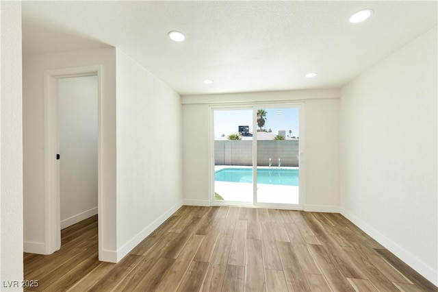 4135 E Harmon Ave, Las Vegas, NV 89121 - unfurnished room with wood finished floors and recessed lighting
