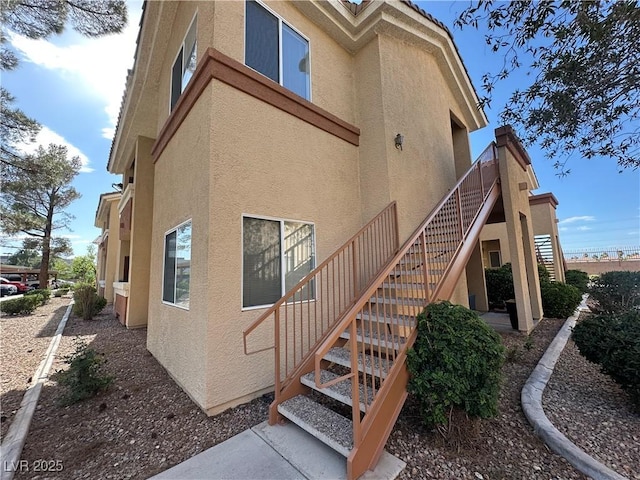 1050 E Cactus Ave Unit 2086, Las Vegas, NV 89183 - view of side of home featuring stucco siding and stairs