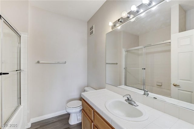 1050 E Cactus Ave Unit 2110, Las Vegas, NV 89183 - bathroom with vanity, shower / bath combination with glass door, and wood finished floors