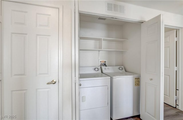 1050 E Cactus Ave Unit 2110, Las Vegas, NV 89183 - washroom featuring washer and dryer and dark wood finished floors