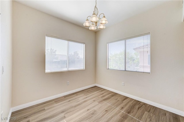 1050 E Cactus Ave Unit 2110, Las Vegas, NV 89183 - empty room with a chandelier and light wood-style floors