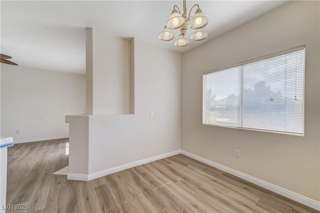 1050 E Cactus Ave Unit 2110, Las Vegas, NV 89183 - spare room with light wood-type flooring, a chandelier, and a ceiling fan