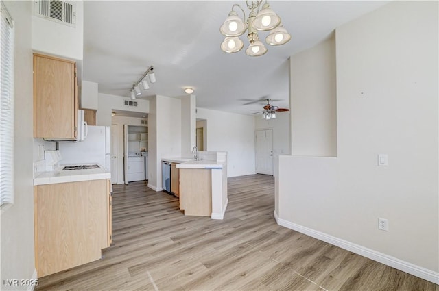 1050 E Cactus Ave Unit 2110, Las Vegas, NV 89183 - kitchen with light countertops, light brown cabinets, a peninsula, and light wood-style floors