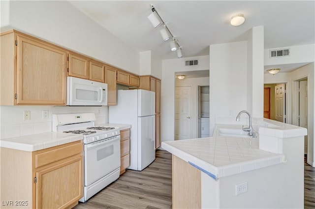 1050 E Cactus Ave Unit 2110, Las Vegas, NV 89183 - kitchen with white appliances, light brown cabinetry, tile counters, and light wood-style floors