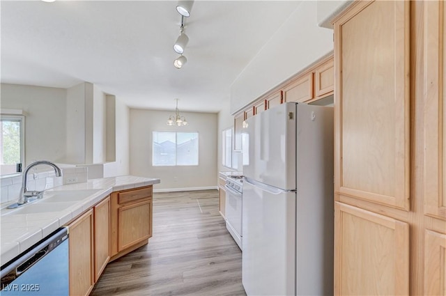 1050 E Cactus Ave Unit 2110, Las Vegas, NV 89183 - kitchen featuring white appliances, tile countertops, light brown cabinetry, a chandelier, and light wood finished floors