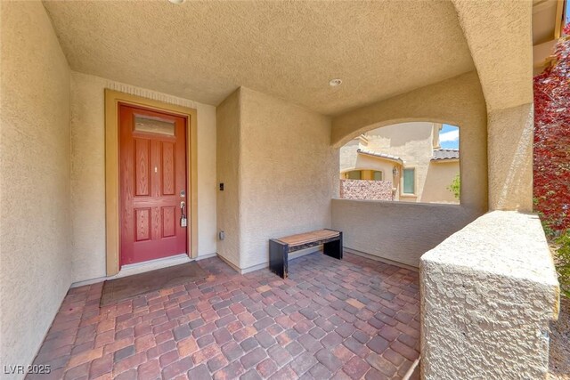 12313 Old Muirfield St, Las Vegas, NV 89141 - entrance to property with stucco siding and a balcony