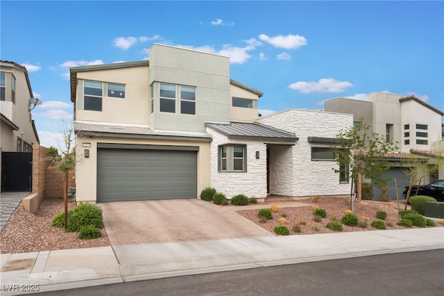 10280 Midnight Meteor Ave, Las Vegas, NV 89166 - view of front of home with stone siding, stucco siding, a garage, and decorative driveway