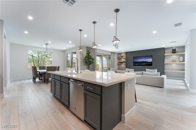 10280 Midnight Meteor Ave, Las Vegas, NV 89166 - kitchen featuring stainless steel dishwasher, gray cabinetry, light countertops, light wood-style floors, and recessed lighting