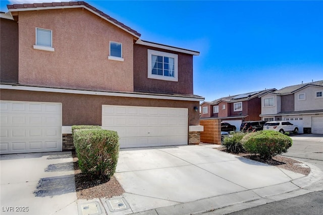 3673 Calypso Beach Ct, Las Vegas, NV 89115 - townhome / multi-family property with stucco siding, concrete driveway, a residential view, and an attached garage