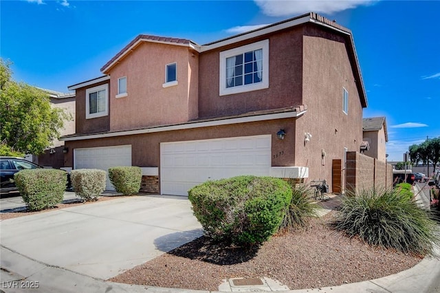 3673 Calypso Beach Ct, Las Vegas, NV 89115 - view of front of home with an attached garage, stucco siding, and concrete driveway