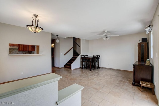 3673 Calypso Beach Ct, Las Vegas, NV 89115 - living room with ceiling fan, stairs, and light tile patterned floors