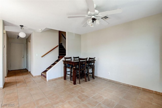 3673 Calypso Beach Ct, Las Vegas, NV 89115 - dining space featuring stairs, ceiling fan, and light tile patterned floors