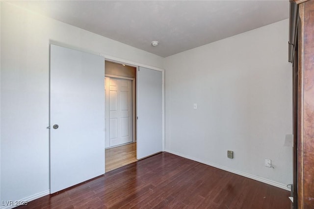 3673 Calypso Beach Ct, Las Vegas, NV 89115 - unfurnished bedroom with dark wood-style flooring and baseboards