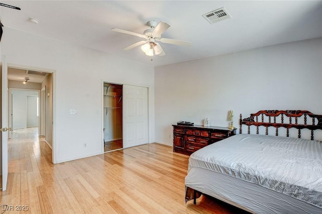 3673 Calypso Beach Ct, Las Vegas, NV 89115 - bedroom with light wood-type flooring, ceiling fan, a closet, and attic access