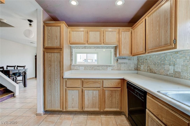 3673 Calypso Beach Ct, Las Vegas, NV 89115 - kitchen with black dishwasher, light tile patterned floors, backsplash, light countertops, and light brown cabinetry