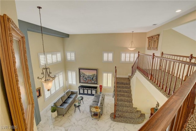 7613 Hackensack Ct, Las Vegas, NV 89128 - living room with marble look tiles, stairway, and recessed lighting
