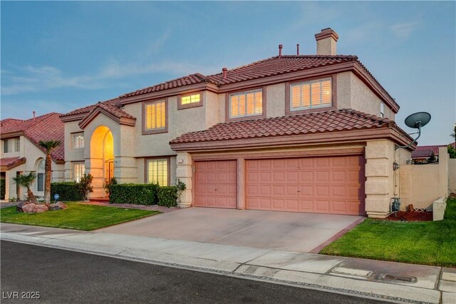 7613 Hackensack Ct, Las Vegas, NV 89128 - mediterranean / spanish-style home with concrete driveway, an attached garage, a chimney, a tiled roof, and stucco siding