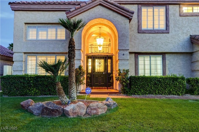 7613 Hackensack Ct, Las Vegas, NV 89128 - property entrance featuring a yard and stucco siding