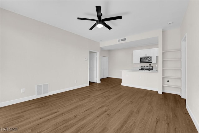 5174 S Jones Blvd Unit 105, Las Vegas, NV 89118 - unfurnished living room featuring wood finished floors and a ceiling fan